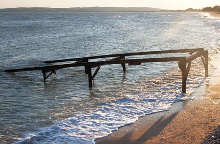 Sea surf wave and structure for launch boat in seaの写真素材