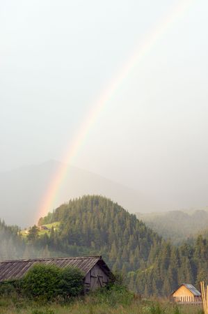 rainbow over mountain village after the rainの写真素材