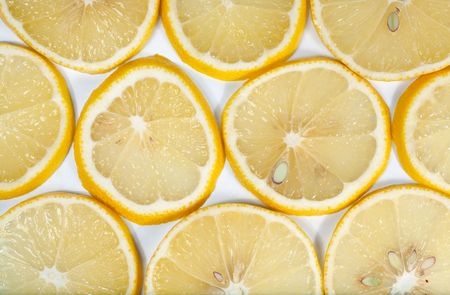 Yellow lemon macro sliced cuts on light background