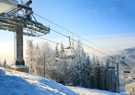 winter morning mountain landscape with ski lift and skiing slopeの写真素材