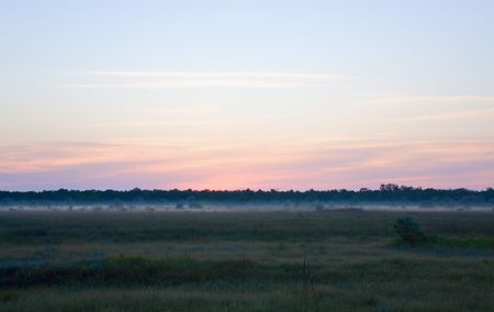 Sunrise sky above the prairie and morning mistの写真素材