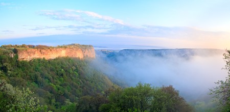 Morning misty view from top of Mangup Kale - historic fortress and ancient cave settlement in Crimea (Ukraine) in sunshine rays. Two shots stitch image.の写真素材
