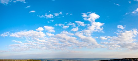 Morning blue sky panorama with cumulus cloud over Crimea mountain plateau. Two shots stitch image.の写真素材