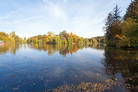 Pond water surface with reflection of colorful trees  in autumn parkの写真素材