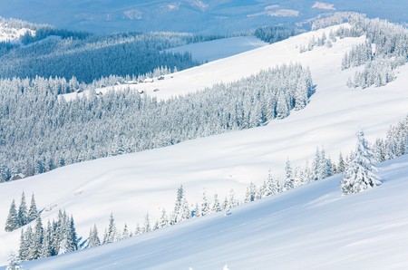 winter calm mountain landscape with sheds group on slope (Kukol Mount, Carpathian Mountains, Ukraine)の写真素材