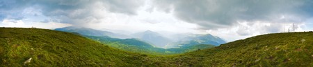 Cloudy stormy sky above  Chornogora Ridge (Carpathian, Ukraine) and family on Goverla Mountain top....