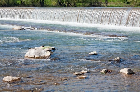 River surface with drop of water and stones.の写真素材