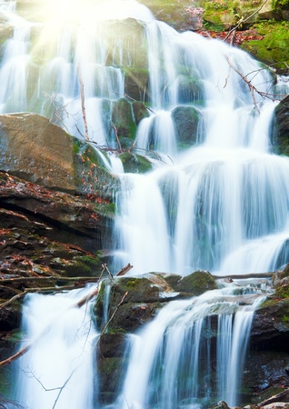 Waterfalls on Rocky Stream, Running Through Autumn Mountain Forest, and sunshineの写真素材