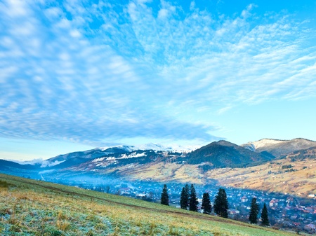 Misty early daybreak in autumn Carpathian mountain, Ukraine (Jasynja Village and Svydovets Range in far)の写真素材