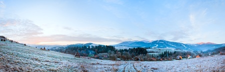 First autumn frost on pasture with haystacks and sunrise in the mountains village.  Three shots stitch image.の写真素材