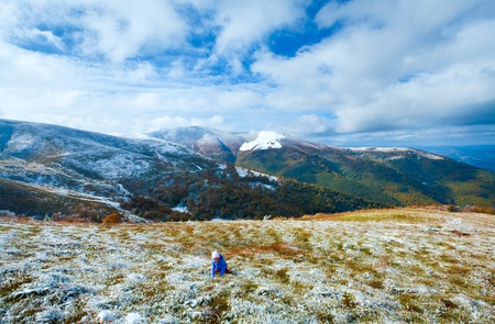 October Carpathian mountain Borghava plateau with first winter snow and playing girl on walkの写真素材