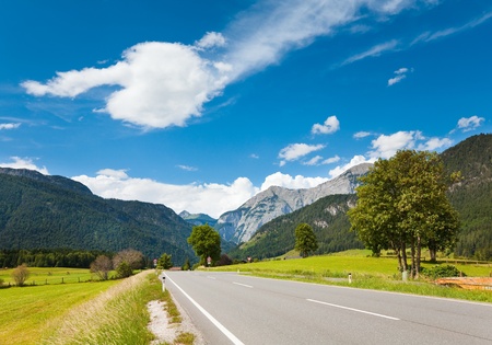 Alps mountain tranquil summer view with road (Austria, Gosau village outskirts)の写真素材