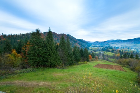 Autumn misty mountain landscape (dull day) with village in valley (Carpathian, Ukraine)の写真素材