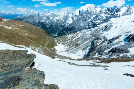 Summer Stelvio pass with alpine road and snow on slope (Italy)の写真素材