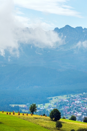 Summer misty mountain village outskirts with Tatra range  (Gliczarow Gorny, Poland)の写真素材