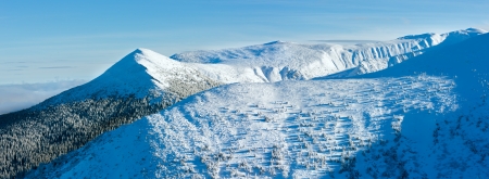 Winter mountain landscape with snowy slopes.の写真素材