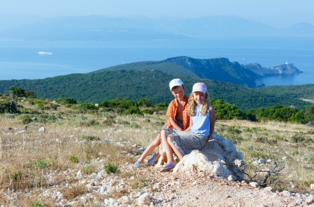 Two children and South cape of Lefkas island (Greece)の写真素材