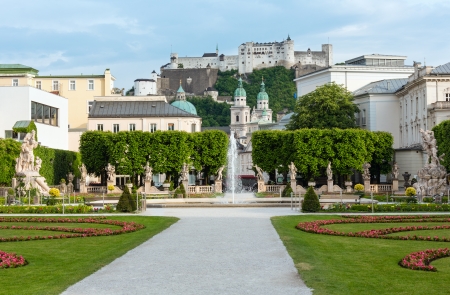 Summer city Gardens of Mirabell Palace with flowerbeds, fountain and statues and Hohensalzburg Fortress behind (Salzburg, Austria)のeditorial素材