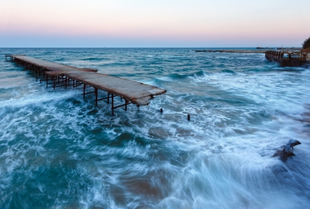Evening sea storm and ruined pier (Black Sea, Bulgaria).の写真素材