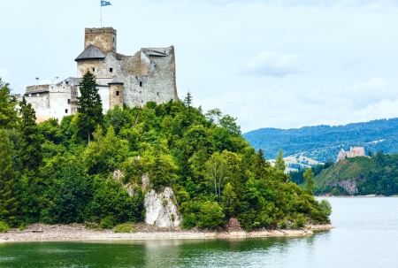 Niedzica Castle (or Dunajec Castle) summer cloudy view (Poland). Build between the years 1320 and 1326. And ruins of Czorsztyn Castle (on the right, 14th century)のeditorial素材