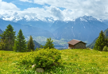Summer mountain landscape with snow on mount top and house on slope (Alps, Switzerland)のeditorial素材