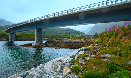 Norwegian Sea cloudy night view with stony coast and bridge (not far Vagan, Norway).の写真素材