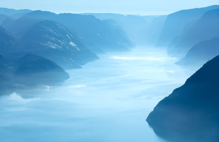 Summer morning misty view from Preikestolen massive cliff top (Norway, Lysefjorden)の写真素材