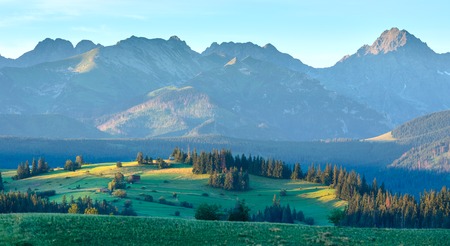 Summer sunrise mountain village outskirts view and Tatra range behind (Poland)の写真素材