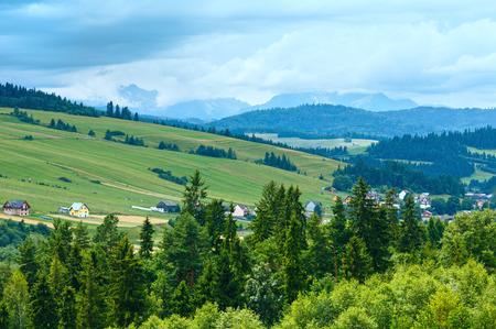 Summer cloudy mountain village near lake Czorsztyn, Poland.の写真素材