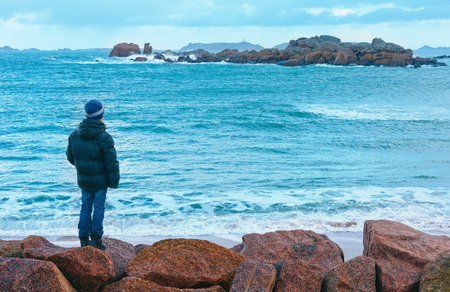Boy to look on ocean. Tregastel coast morning spring view  (between Perros-Guirec and Pleumeur-Bodou, Brittany, France). The Pink Granite Coast.の写真素材