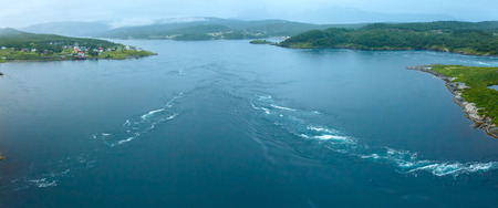 Fjord summer night view from bridge with flowing water (Norway)の写真素材