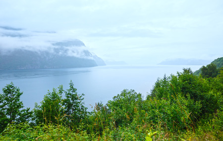 Summer misty sea coast view with low clouds (Norway).の写真素材