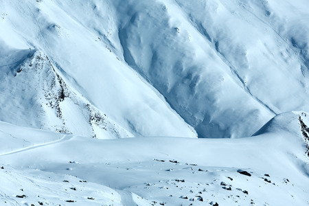 Morning winter mountain slope with ski track (Tyrol, Austria).の写真素材