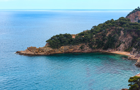 Summer sea rocky coast view with small sandy beach. Costa Brava, Catalonia, Spain.
