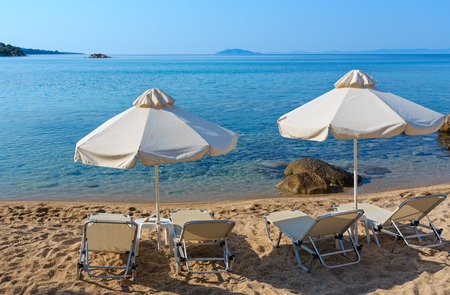 Summer morning sandy Platanitsi beach with sunbeds and sunshades (Chalkidiki, Greece).の写真素材