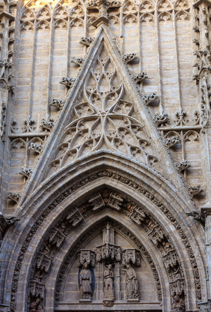Architecture details over entrance door of Seville Cathedral (or Cathedral of Saint Mary of the See). Build in 1402-1506.の写真素材