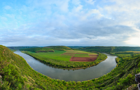 Top picturesque evening view of the Dnister river bend canyon, with spring fields on coast. Ternopil region, Ukraine, Europe. Four shots stitch high-resolution panorama.の写真素材