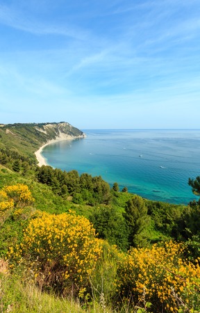Summer Adriatic sea bay and blossoming Spiaggia Mezzavalle beach near Portonovo and Ancona towns in the Marche region. Italy, Conero Riviera. People unrecognizable.の写真素材