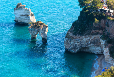 Picturesque islets Faraglioni di Puglia in summer Adriatic sea bay Baia Delle Zagare (Mattinata, Gargano peninsula, Puglia, Italy)の写真素材