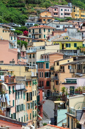 Beautiful summer Riomaggiore - one of five famous villages of Cinque Terre National Park in Liguria, Italy, suspended between Ligurian sea and land on sheer cliffs. People unrecognizable.の写真素材