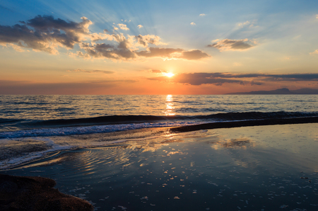 Beautiful landscape with tropical sea sunset on the beach.  Picturesque sky reflection in water.の写真素材