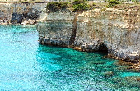 Picturesque seascape with cliffs and rocky arch, at Torre Sant Andrea, Salento sea coast, Puglia, Italy.の写真素材