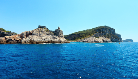 Beautiful medieval fisherman town of Portovenere (UNESCO Heritage Site) view from sea (near Cinque Terre, Liguria, Italy). Fortress Castello Doria and church Chiesa di San Pietro.のeditorial素材