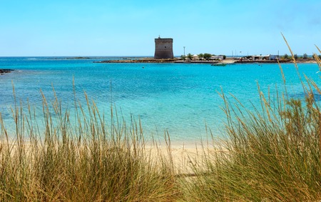 Picturesque Torre Chianca beach and historical fortification tower Torre Chianca (Torre Santo Stefano) on Salento Ionian sea coast, Porto Cesareo, Puglia, Italyの写真素材