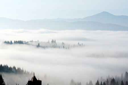 Morning fog on the slopes of the Carpathian Mountains (Yablunytsia village, Ivano-Frankivsk oblast, Ukraine).の写真素材