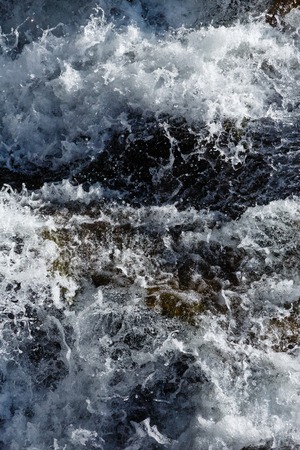 Rapid water of waterfall close-up (nature background).の写真素材