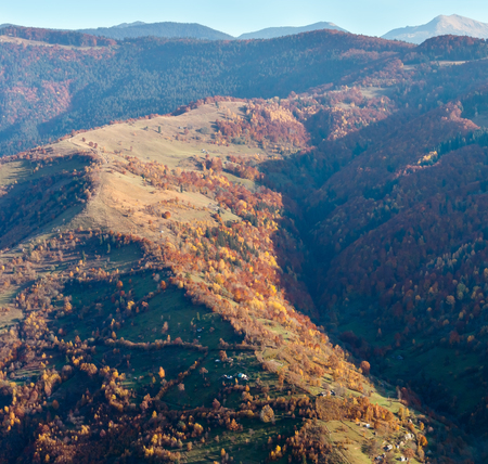 Autumn Carpathian Mountains landscape with multicolored trees and village outskirts on slope (view from Rakhiv pass, Transcarpathia, Ukraine).の写真素材