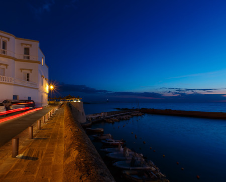 Evening dusk in Gallipoli, province of Lecce, Puglia, southern Italy.  View from walls of Angevine-Aragonese medieval Castle fortressの写真素材