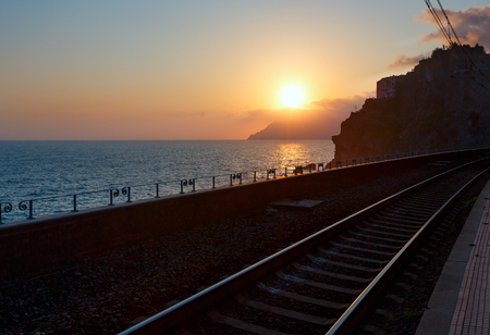 Beautiful sunset in summer Vernazza - one of five famous villages of Cinque Terre National Park in Liguria, Italy. Railwai in front. の写真素材