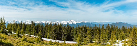 Spring Carpathian mountains landscape with snow-covered tops of Chornohora ridge in far, Ukraine. High-resolution panorama stitch image.の写真素材